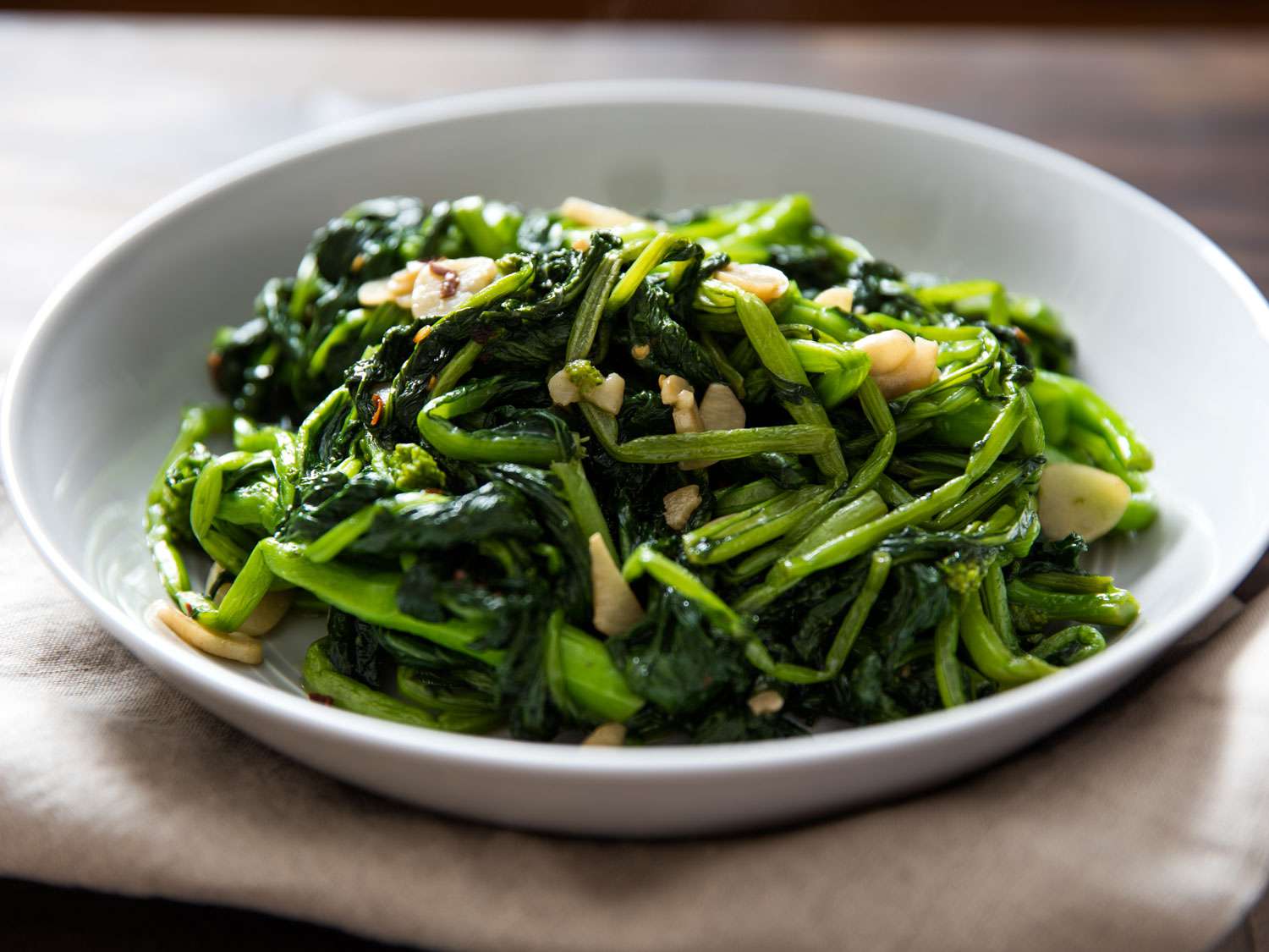 A dish of well-cooked broccoli rabe with garlic and red pepper flakes.