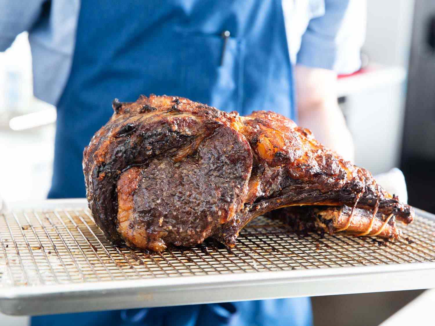 Finished koji prime rib with a burnished brown crust on a wire rack-lined baking sheet.