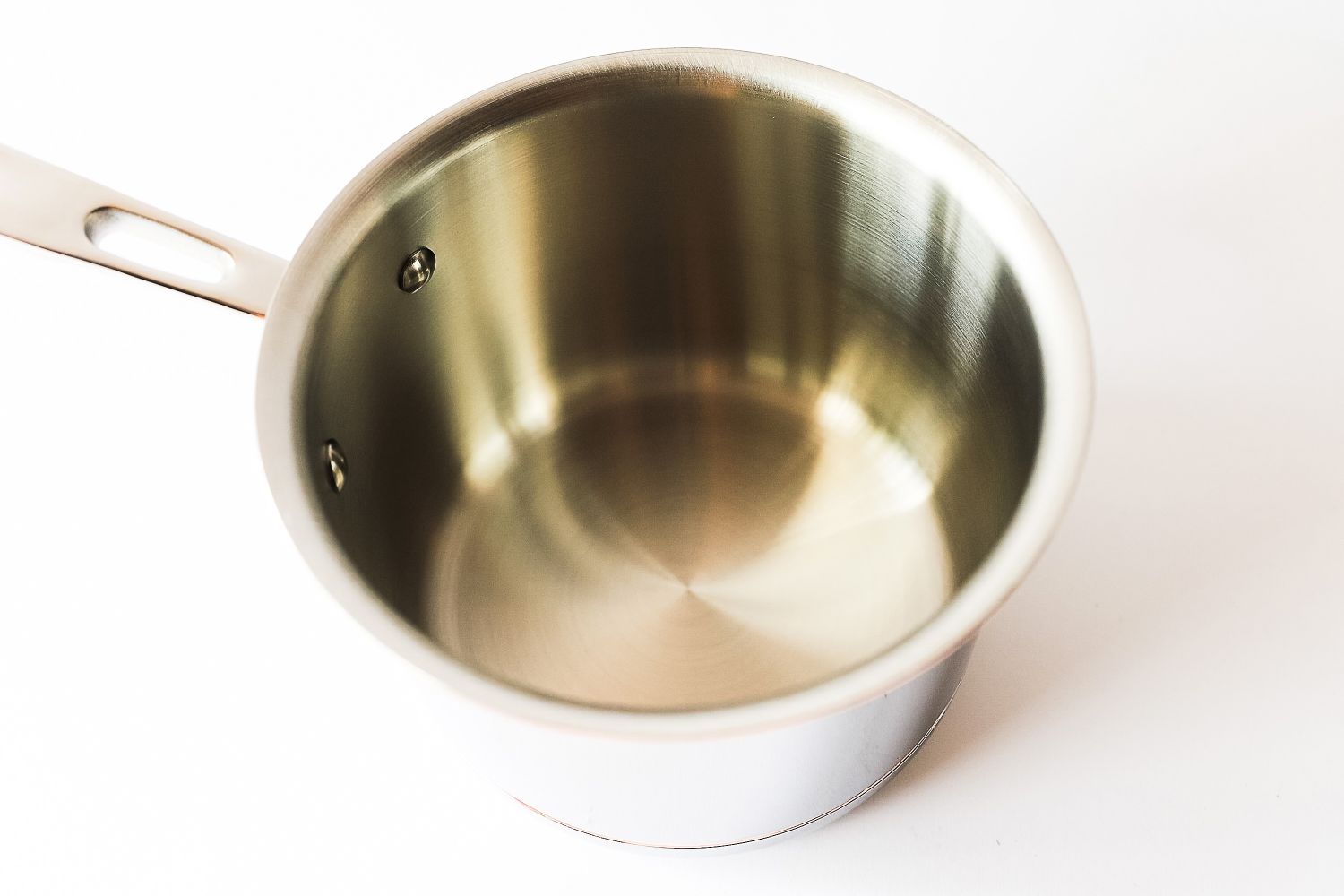 A stainless steel saucepan with a handle