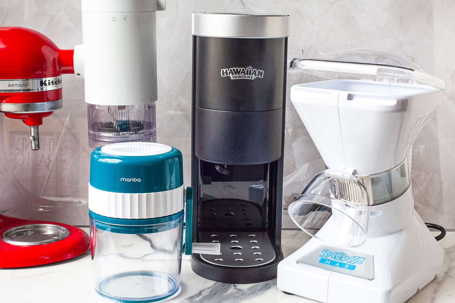 Kitchen countertop with various ice shaving appliances and a red KitchenAid mixer