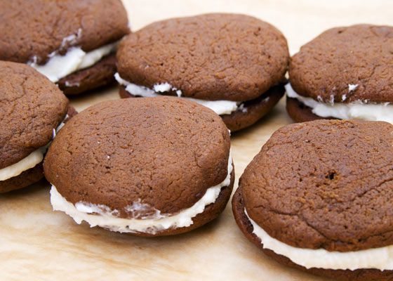 Gingerbread whoopie pies, assembled on a wooden work surface.