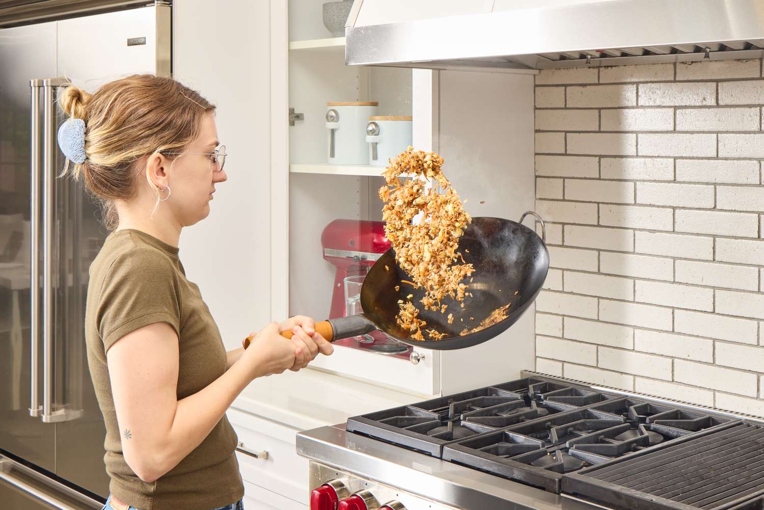 A person cooks rice in the Yosukata Carbon Steel Wok Pan