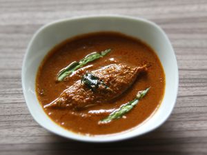 Goan fish curry, served in a small white bowl.