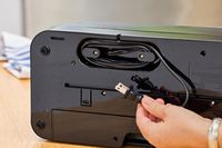 A person holds the cord on the FoodSaver V4400 2-in-1 Vacuum Sealer Machine