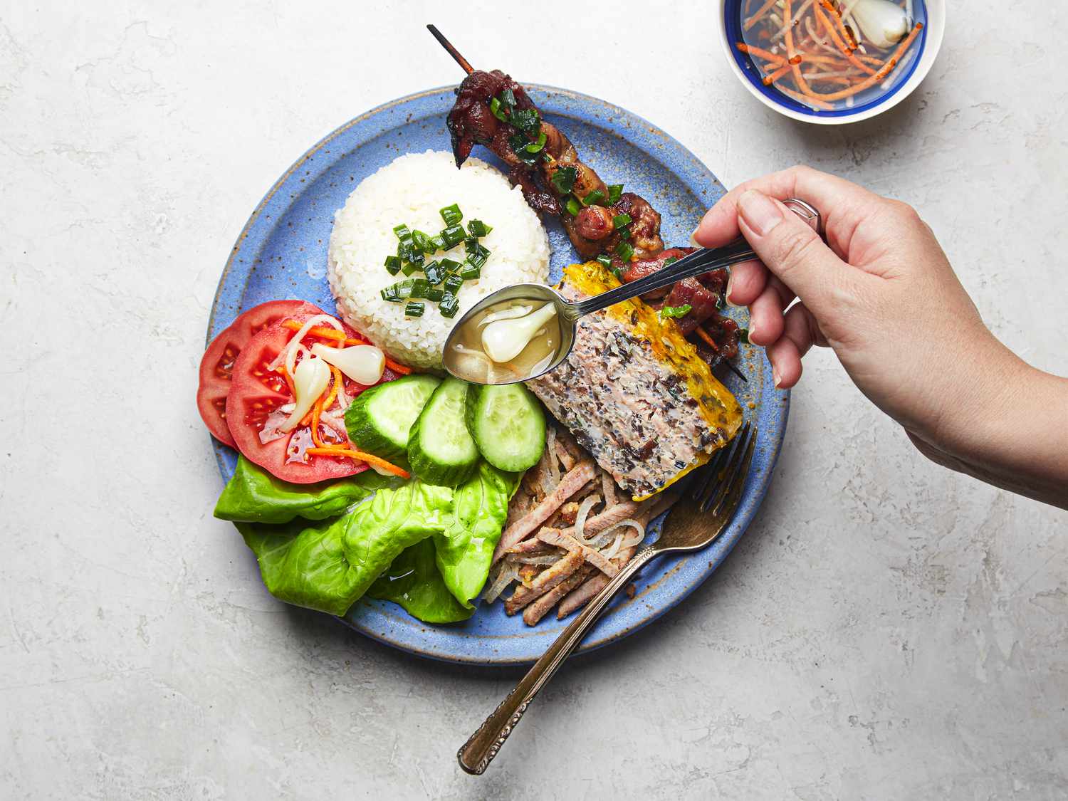 Overhead view of finished platter of broken rice with all elements