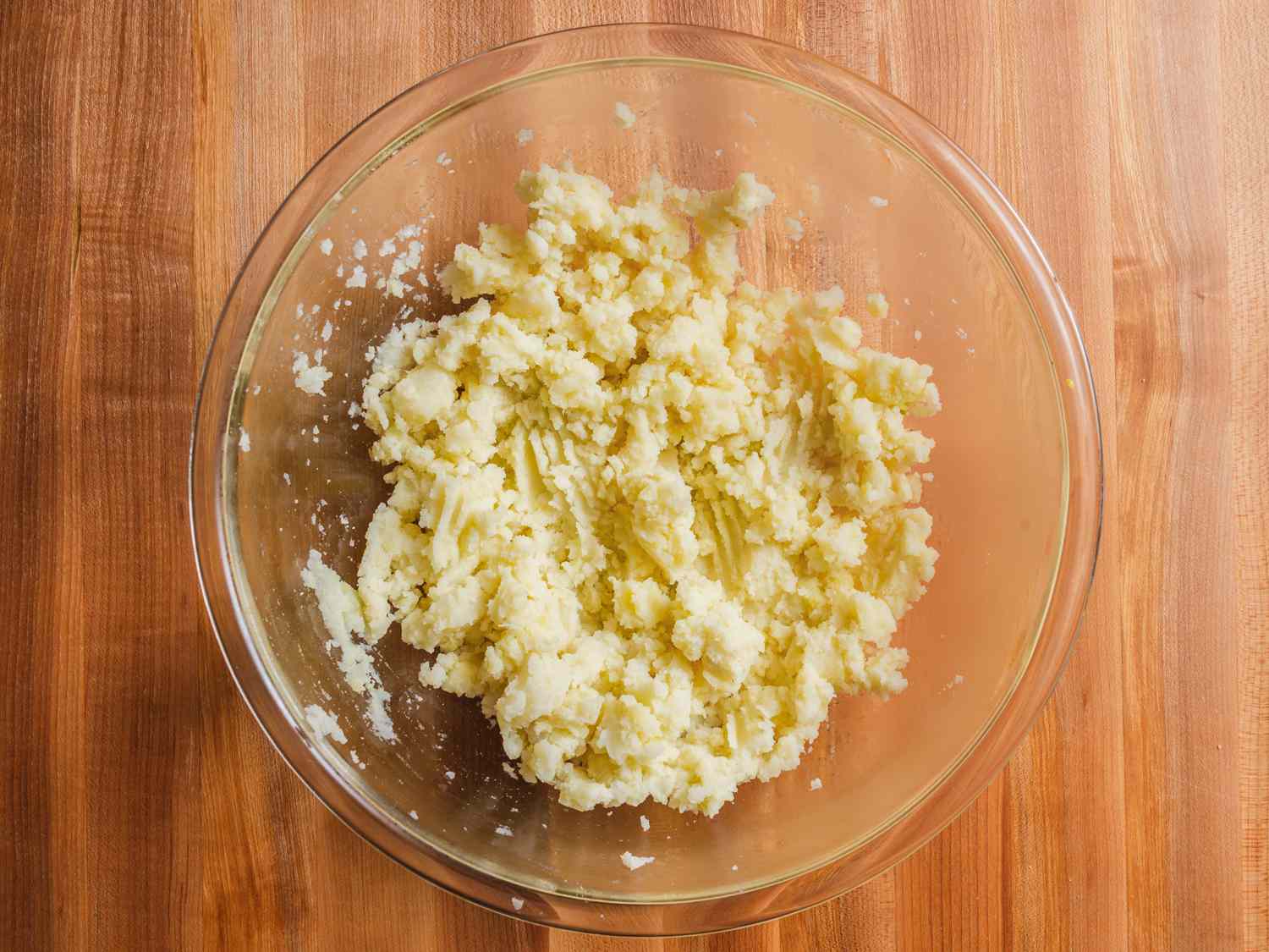 Cooked potatoes after being mashed in a bowl