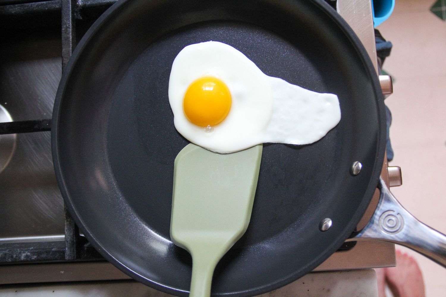 A spatula scooping an egg in the Le Creuset Ceramic Nonstick Frying Pan