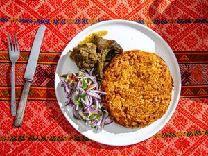 Overhead view of finished tacu tacu on a traditional Peruvian fabric