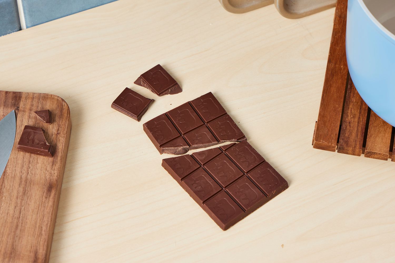 An unwrapped chocolate bar on a kitchen countertop.