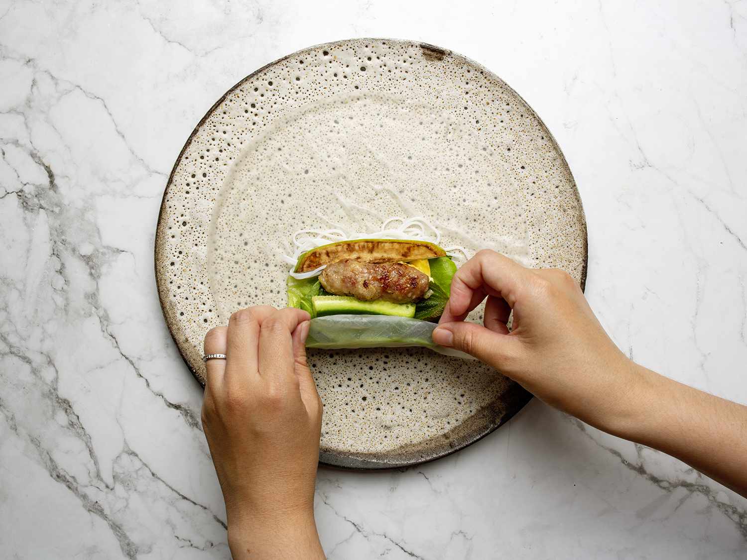 A rice paper roll being assembled