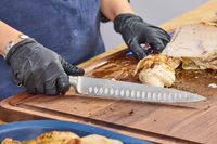 Chicken is sliced with the Wüsthof Classic 9 Inch Hollow Edge Carving Knife