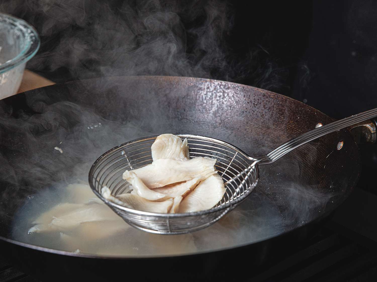 Close up of fish that has been passed-through water in a wok