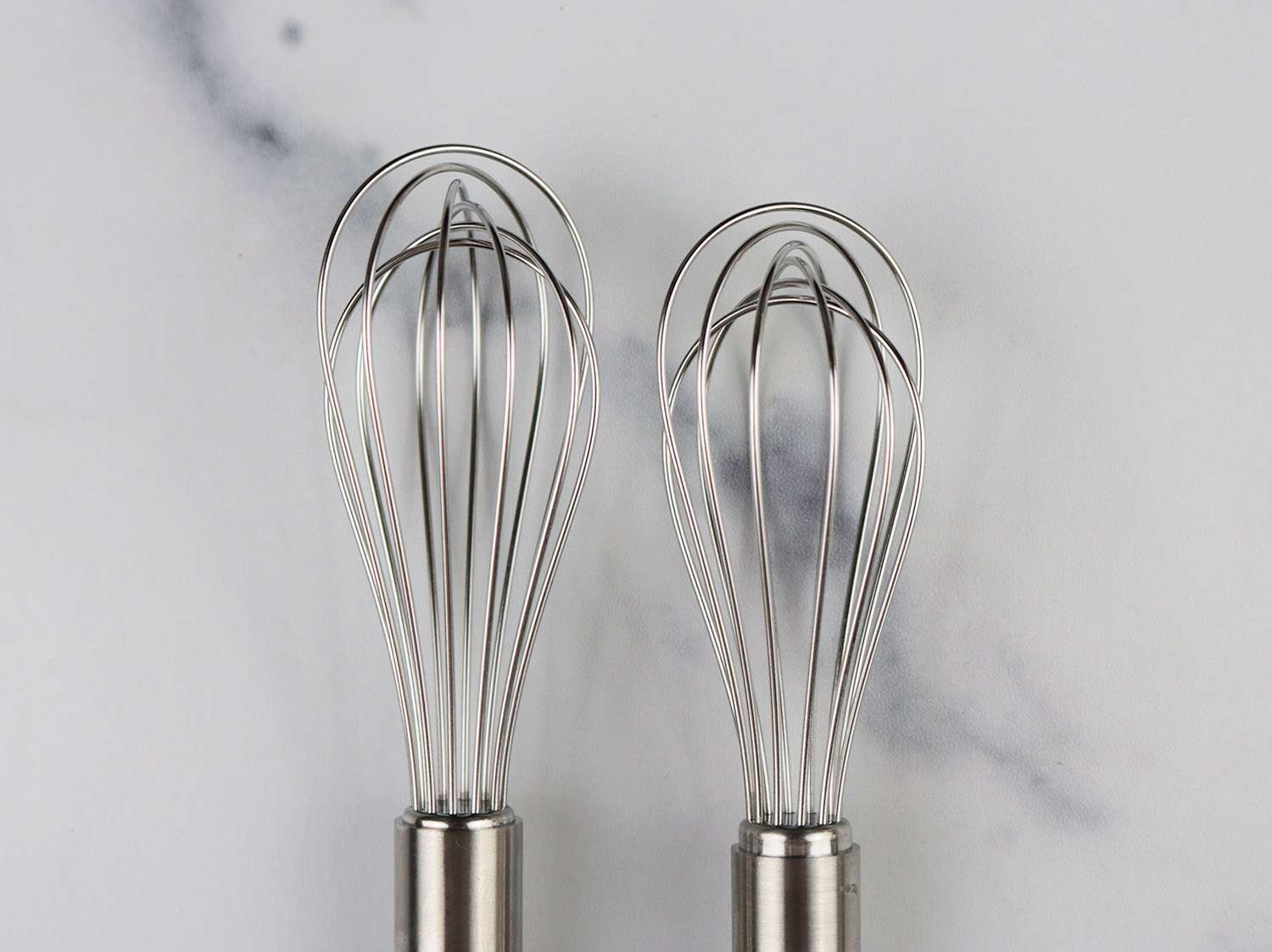 two nearly identical mini whisks 