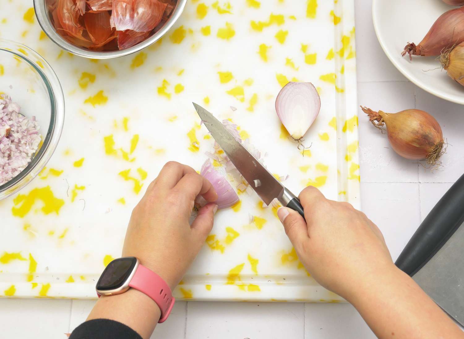 a person dicing a shallot