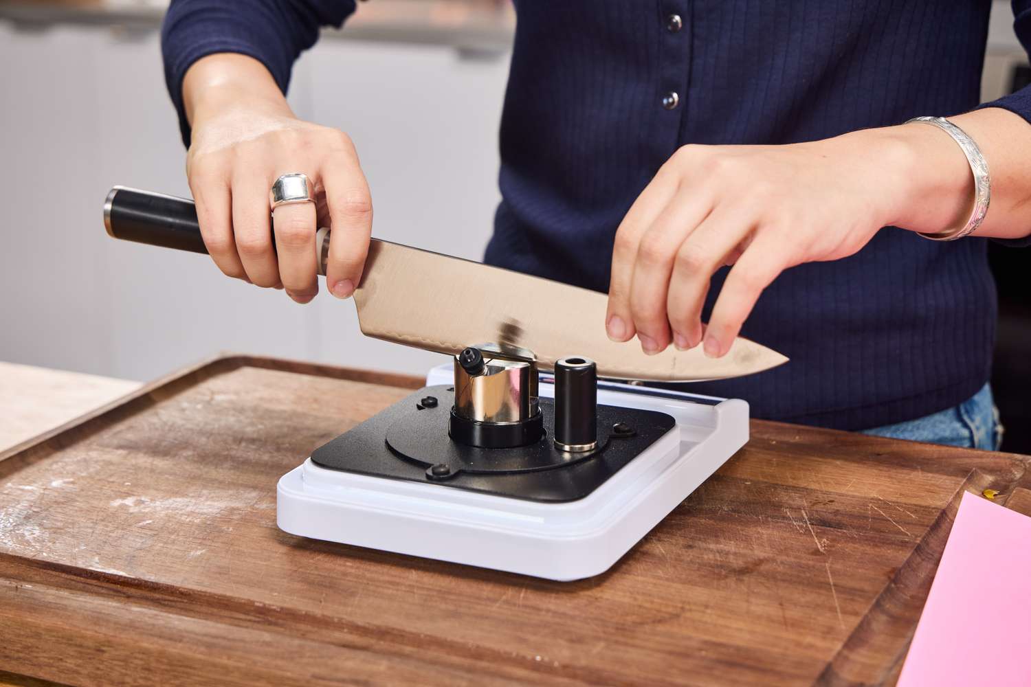 A person sharpens the Material The 8-Inch Knife
