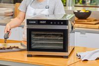 COSORI Food Dehydrator is displayed along a person standing backside