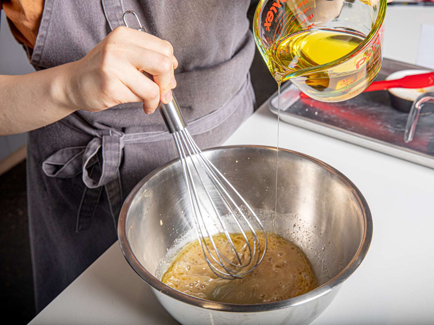 Side angle view of adding oil to emulsify 