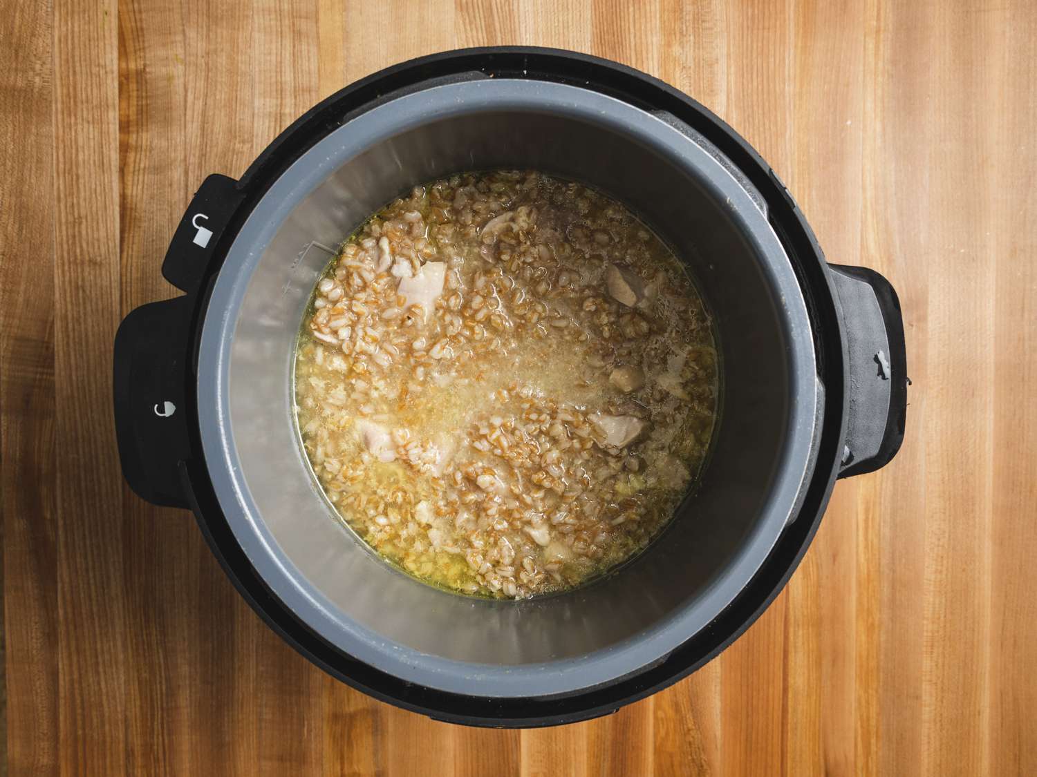 Overhead view of farro, and chicken mixture after it has been cooked in a pressure cooker