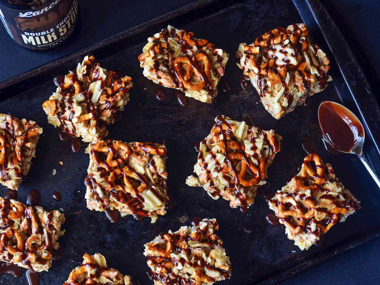 Overhead view of sweet and salty stout marshmallow bars, served on a black platter.