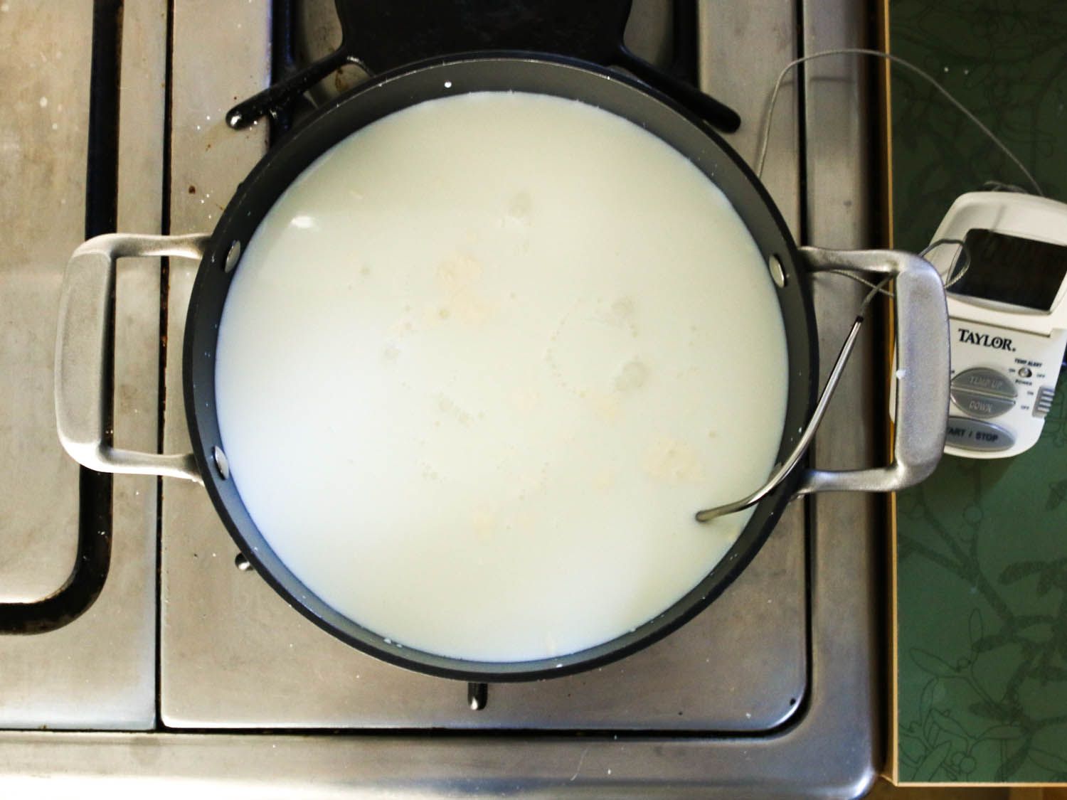 Overhead of a thermometer in curds and whey. 