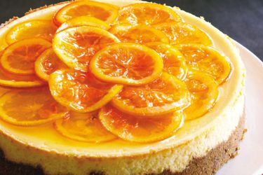 A caramelized orange cheesecake with candied orange slices on top. 