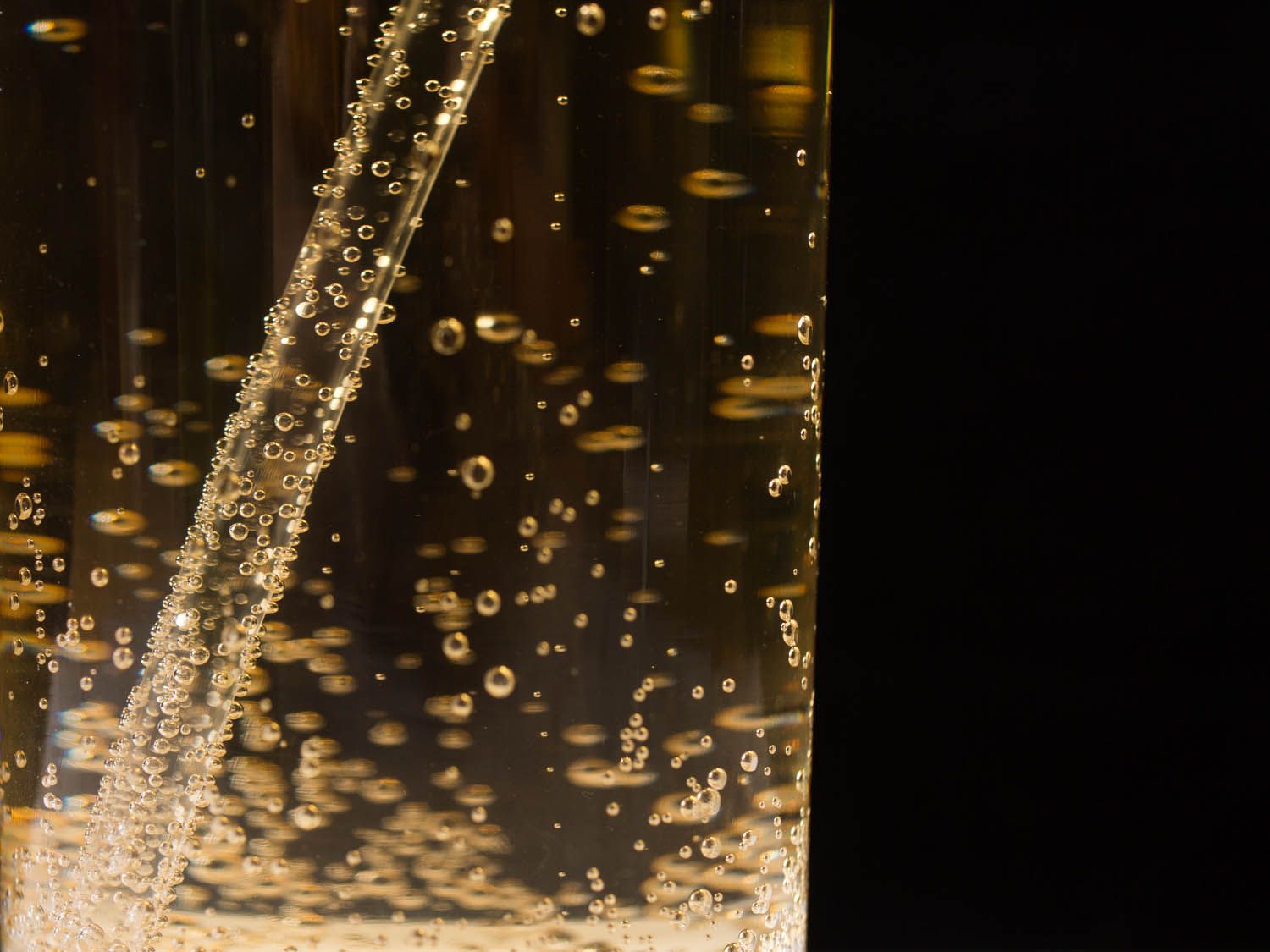 A close-up of a glass filled with bubbling Dr. Brown's Cel-Ray soda.