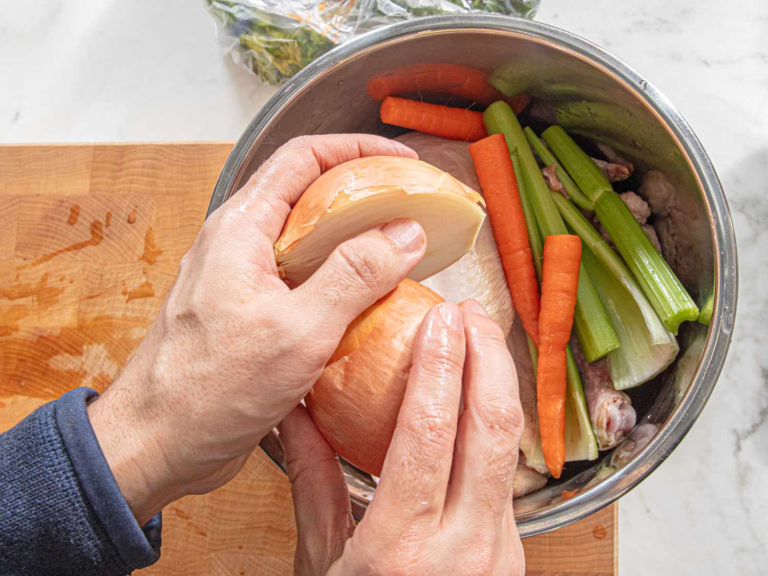 Putting onion with stock into a pot