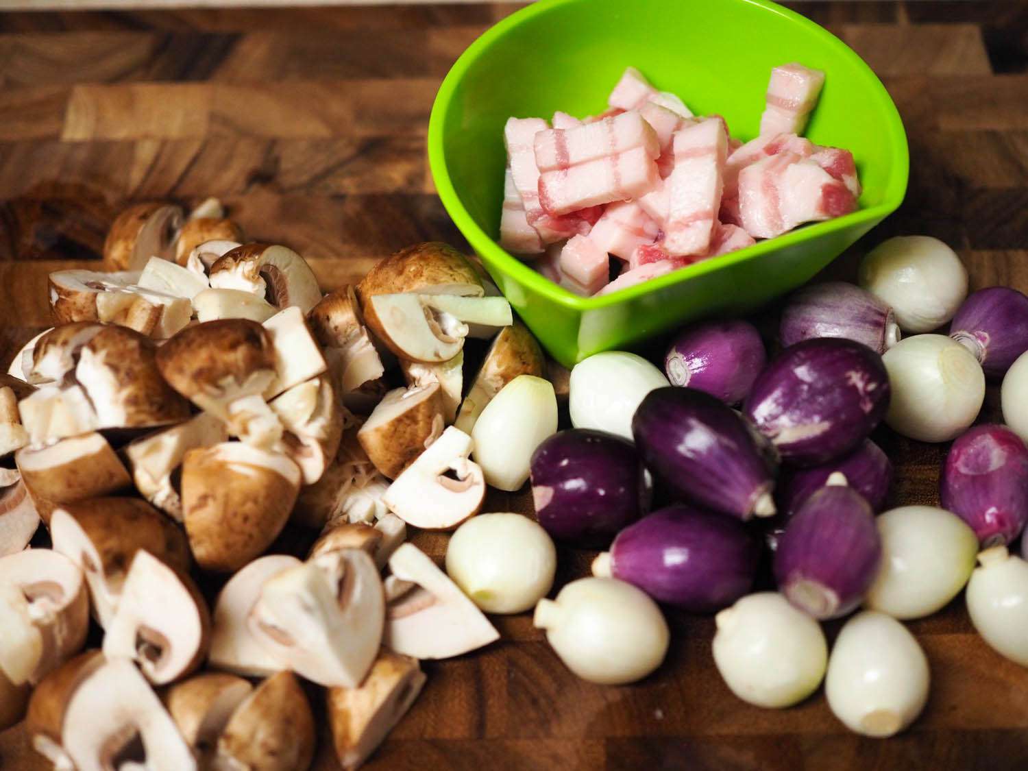 Quartered onions, peeled pearl onions, and lardon prepped and ready to go.