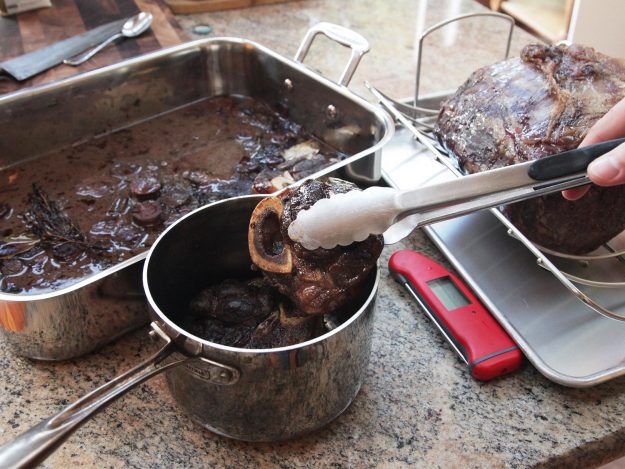 Transferring shins to saucepan for red wine jus.