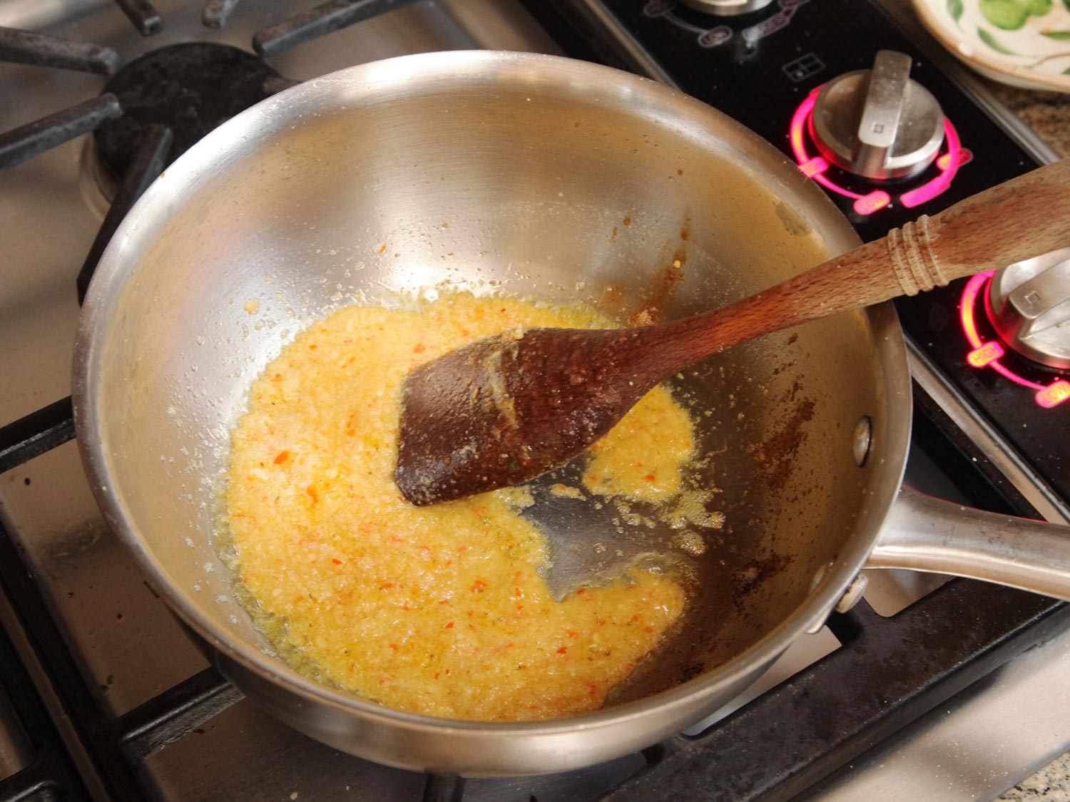 Garlic, ginger, and chiles are cooked in a saucier.