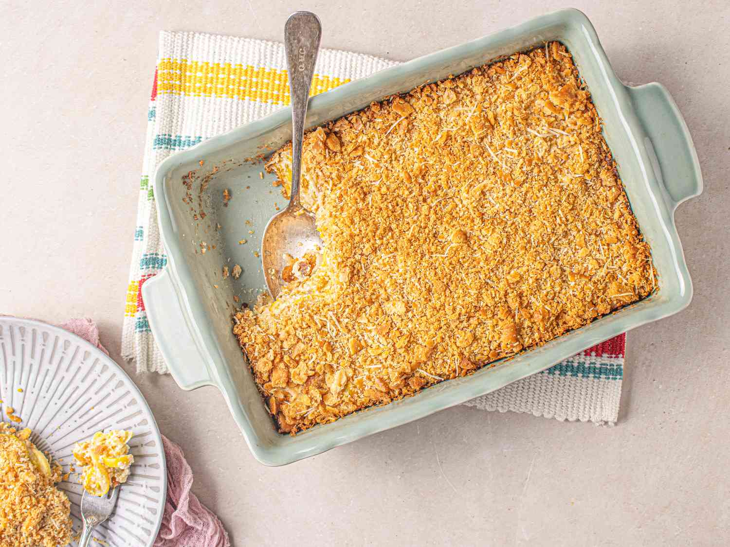 Yellow squash casserole in a large rectangular serving dish.