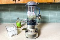 The Breville Fresh and Furious Blender on a kitchen counter with frozen margarita ingredients in the jar
