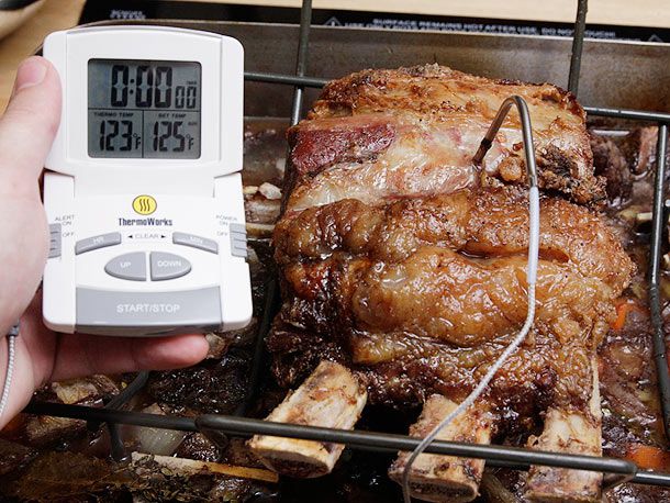 An instant-read thermometer placed into the meat showing a reading of 125 degrees Fahrenheit (51 degrees C).