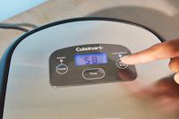 Hand pressing start button Cuisinart ICE-100 Compressor Ice Cream and Gelato Maker