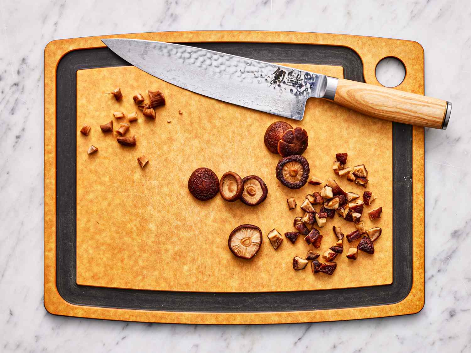 Overhead view of mushrooms chopped on a cutting board 