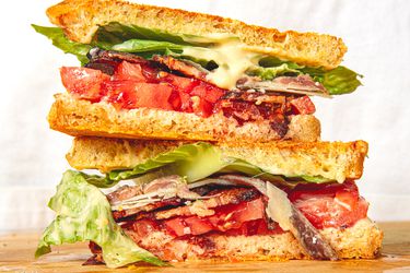 Two halves of the Caesar BLT stacked on top of each other