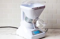 Snowie Little Snowie Max Snow Cone Machine with a transparent ice chute and labeled base