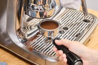 A person makes espresso in the Breville The Oracle Jet Espresso Machine