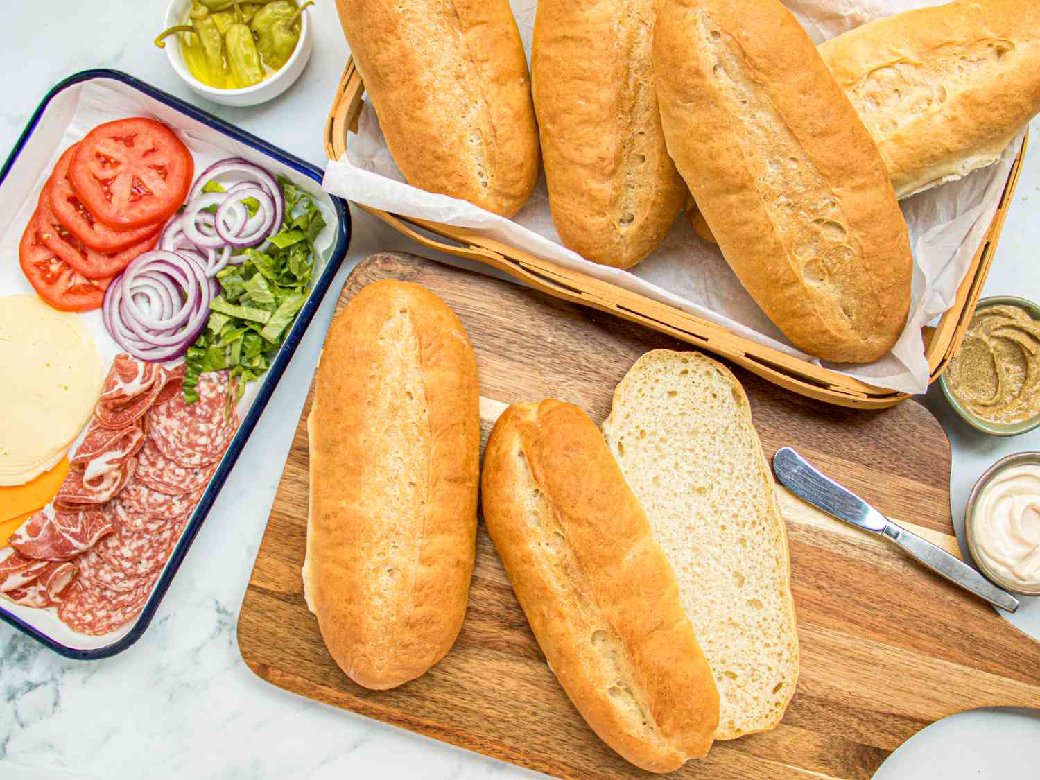 Overhead view of hoagie rolls with sandwich fixings