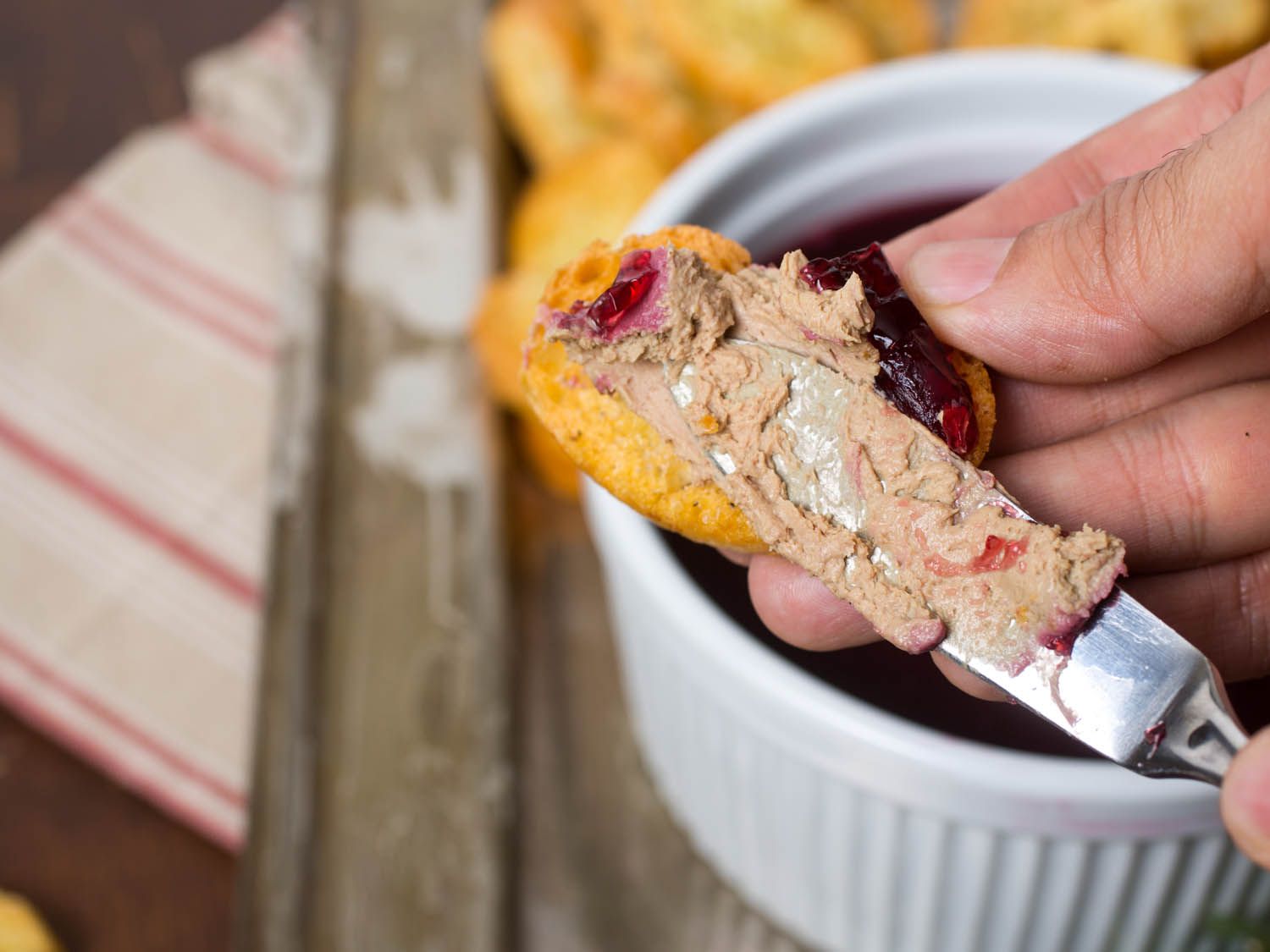 Author spreading liver pate on a piece of bread. 