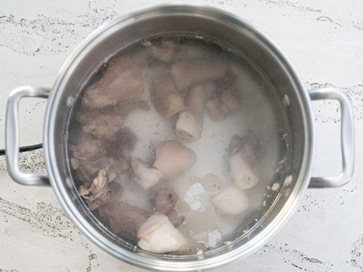Overhead view of meat in pot 
