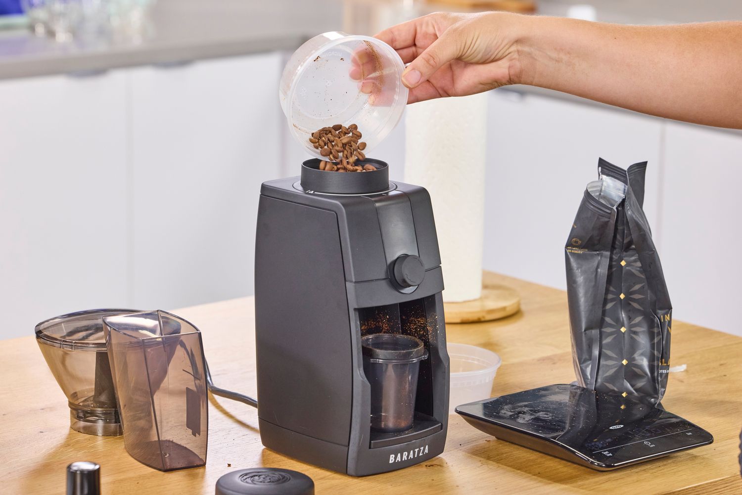 A person pours coffee beans into the Baratza Encore ESP Pro Coffee Grinder