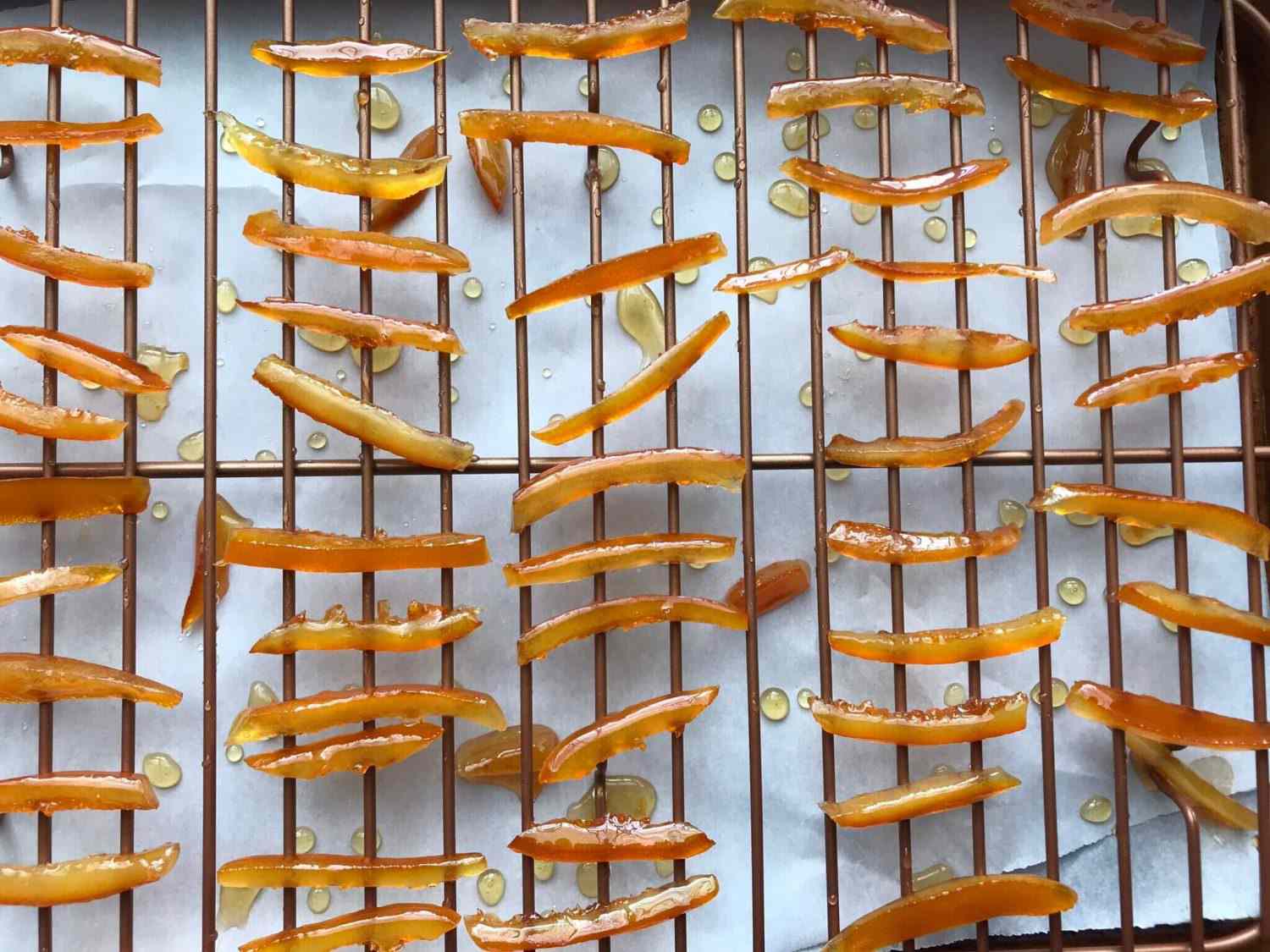 candied orange peel drying on a rack