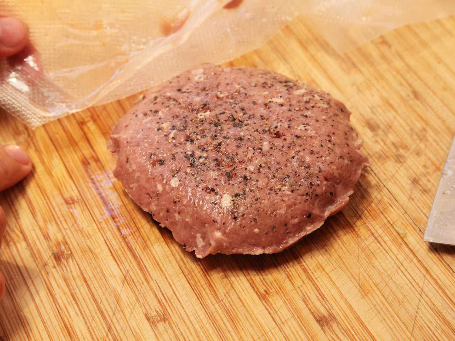 Sous vide hamburger that was sealed in a vacuum bag before cooking, showing over-compression.