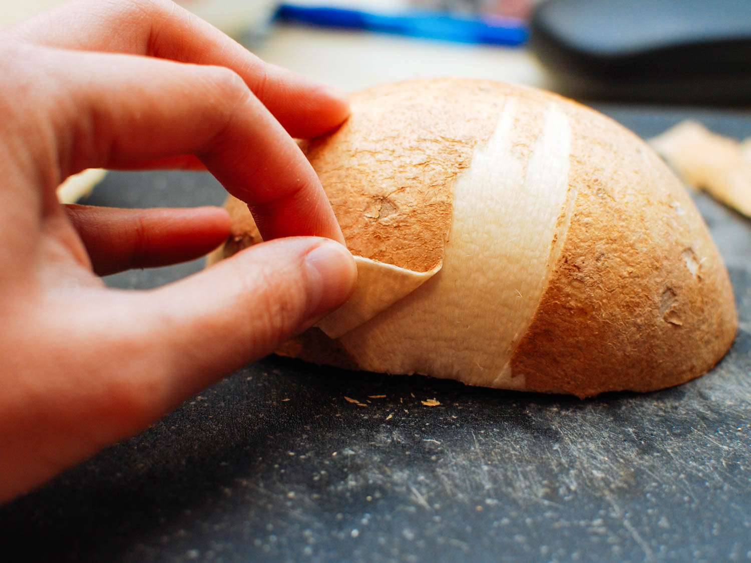 Peeling the skin off of jicama.