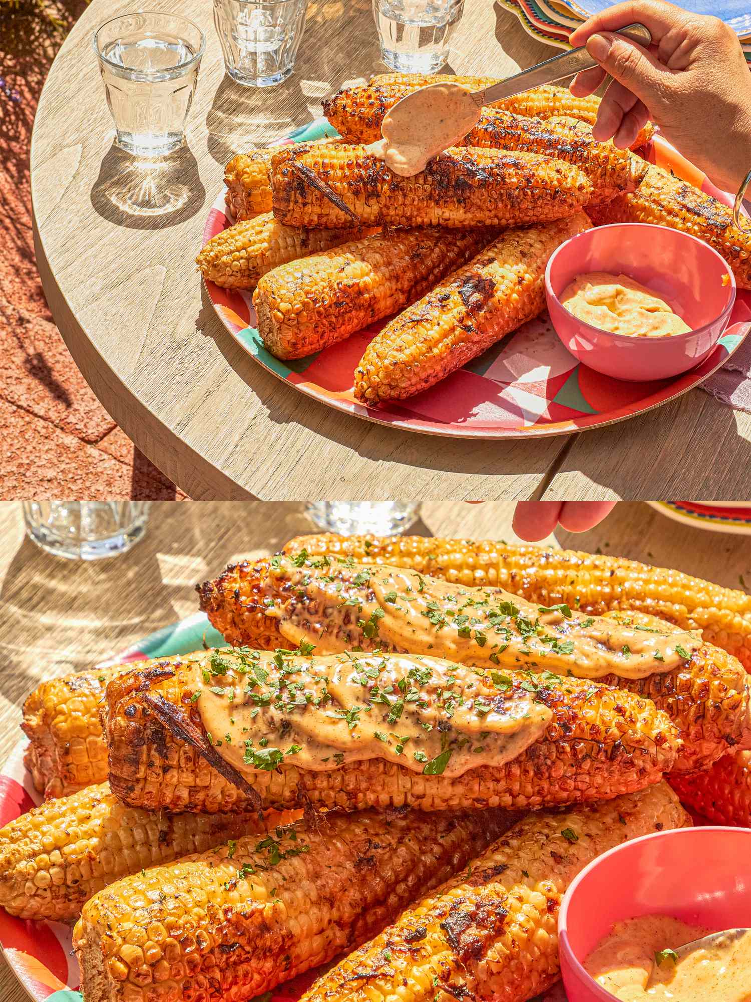 Platter of grilled corn with garnish on a table red bowl of dipping sauce on the side