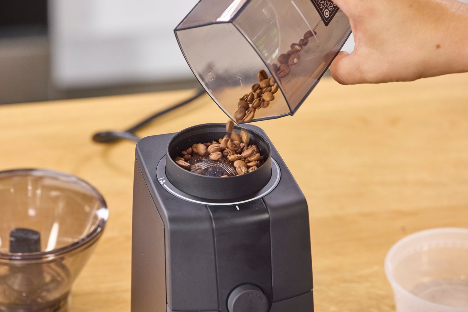 Coffee beans are poured into the Baratza Encore ESP Pro Coffee Grinder