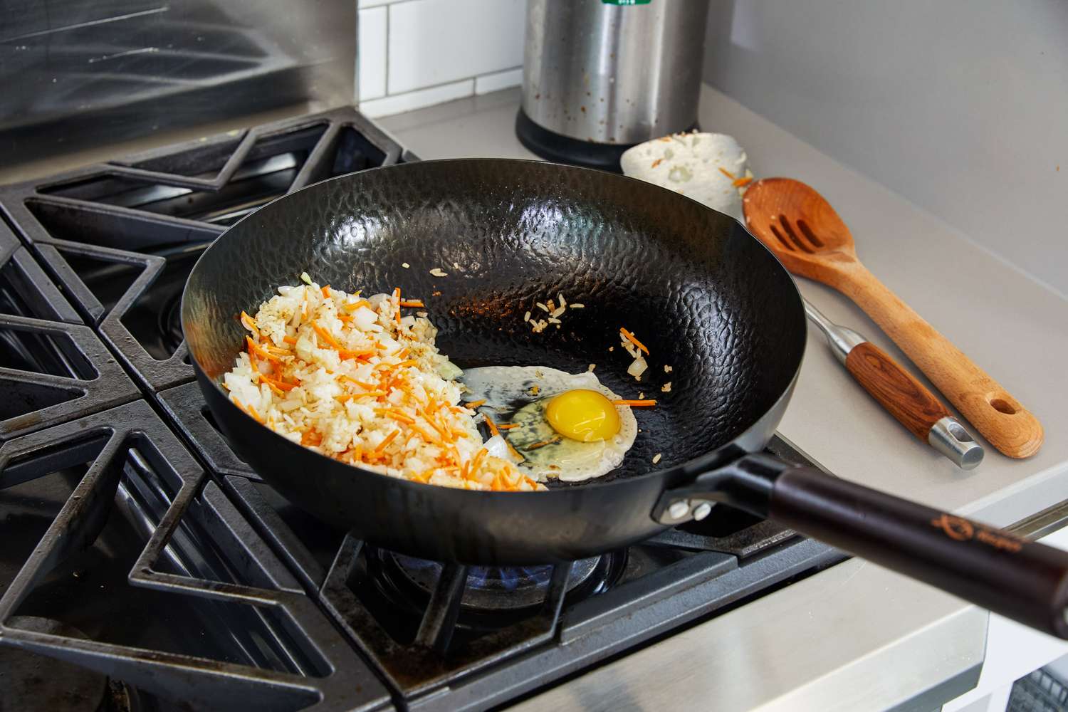 Close up of eggs and hash browns in a Souped Up Recipes Carbon Steel Wok