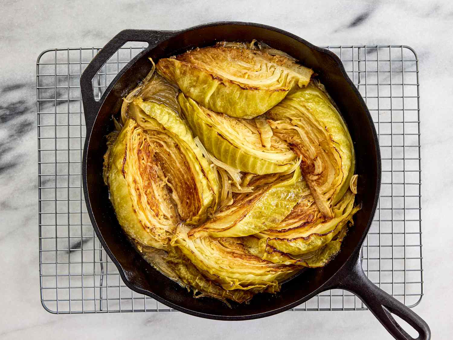 baked cabbage in skillet on cooling rack