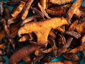 Roasted shiitake mushrooms on a blue plate (close up)